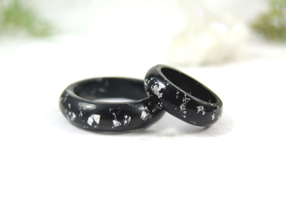 Black resin ring with silver flakes. 