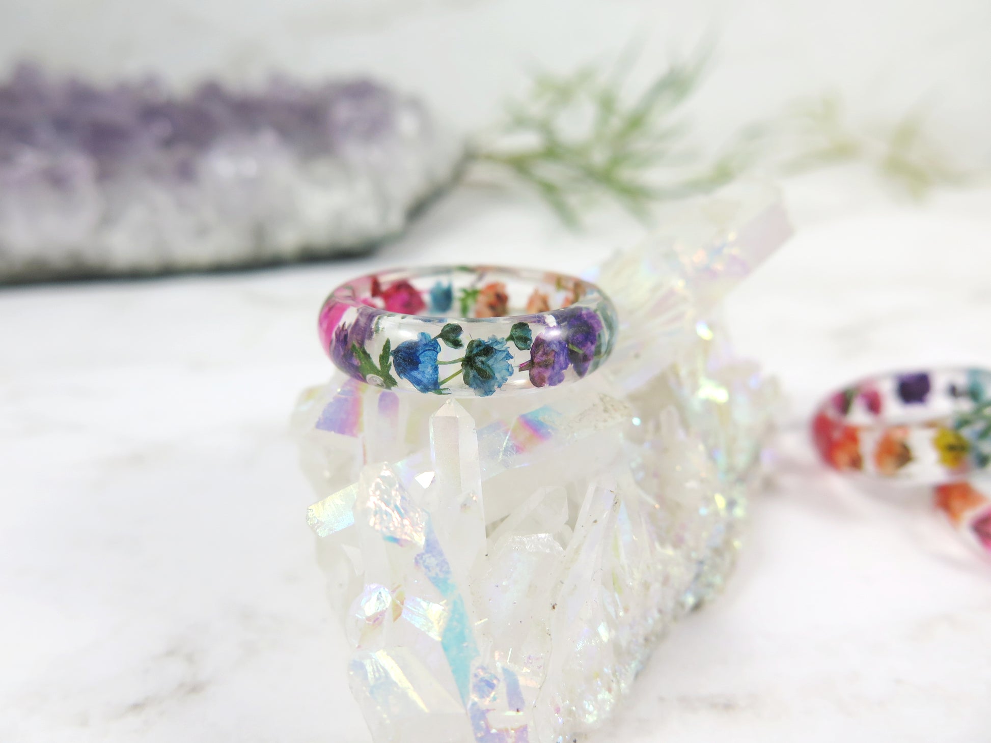 real flowers embeded into crystal clear resin and shaped into band ring