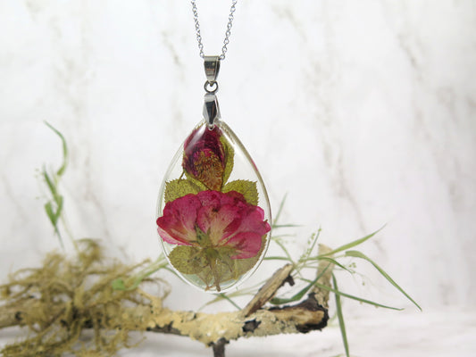 Dried red rose and rose bud in teardrop resin pendat, hang on a sturling silver chain