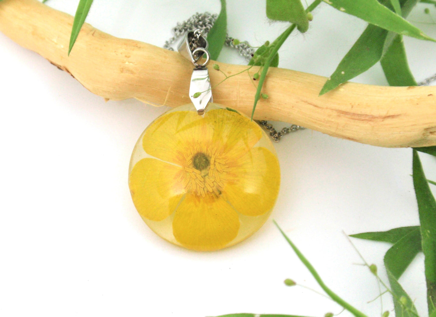 Yellow buttercup flower in resin