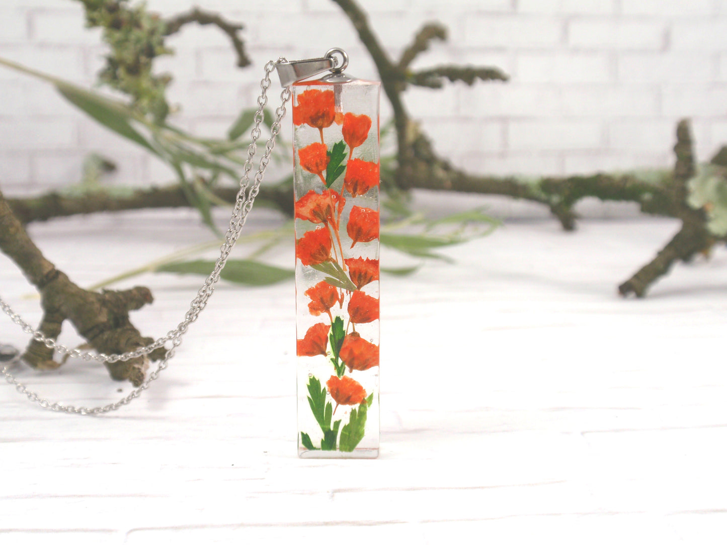 Handmade Terrarium Necklace with orange babys breaht flowers